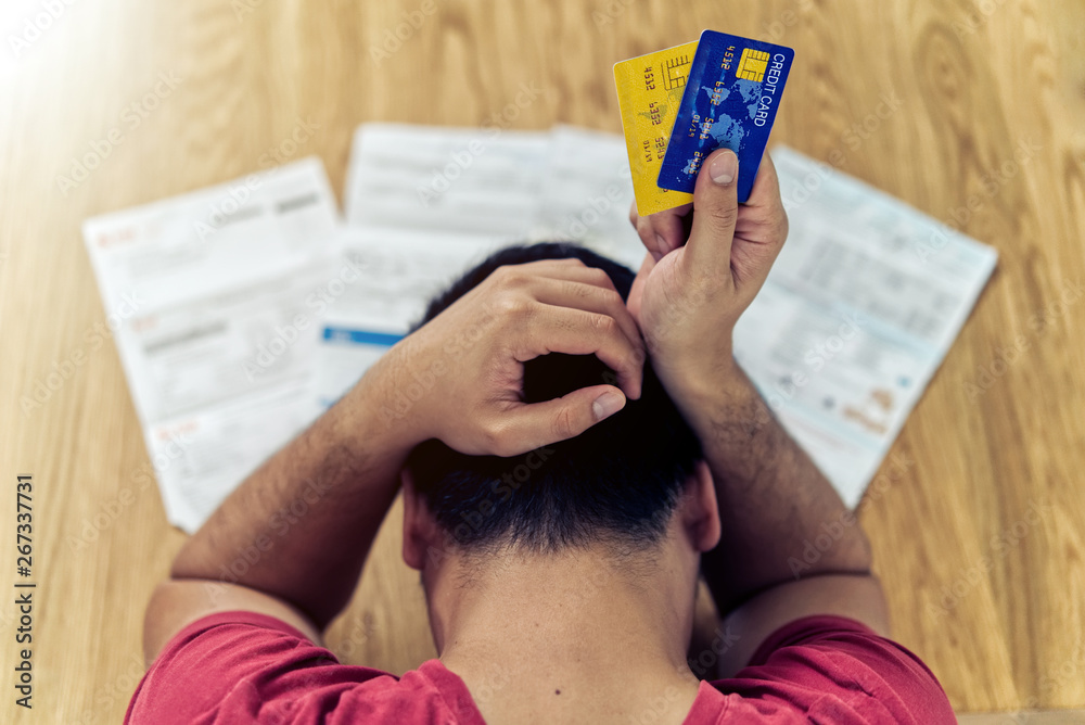 stressed person looking at credit card bills